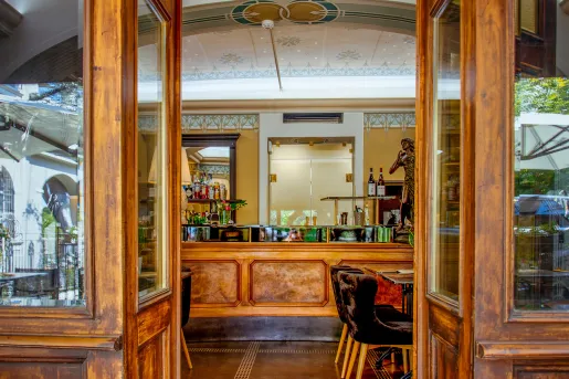 Doorway leading to a bar and lounge with alcohol along the walls