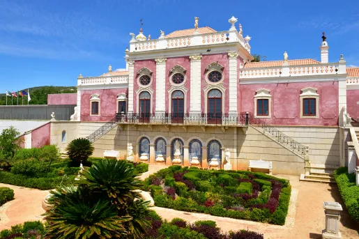 Red brick hotel building with a garden in front