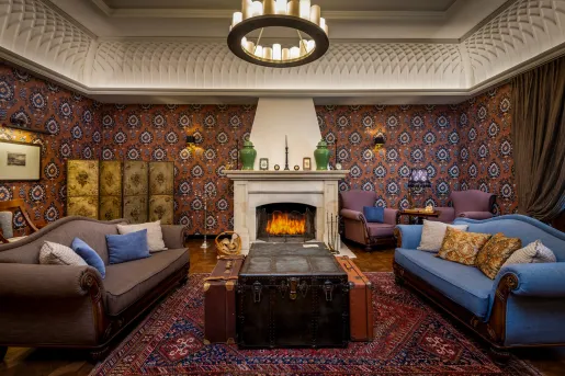 Seating area with a fireplace and two large, cushioned sofas