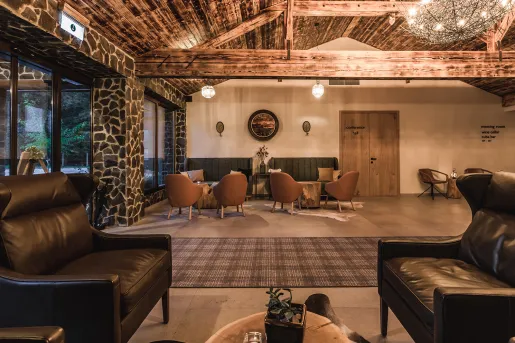 Cabin lobby with stone pillars and leather chairs
