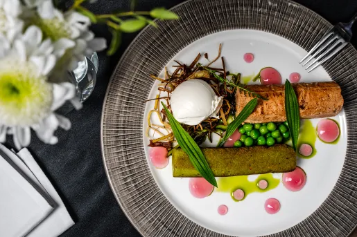 Fancy plate of grilled fish with vegetables and garnishes