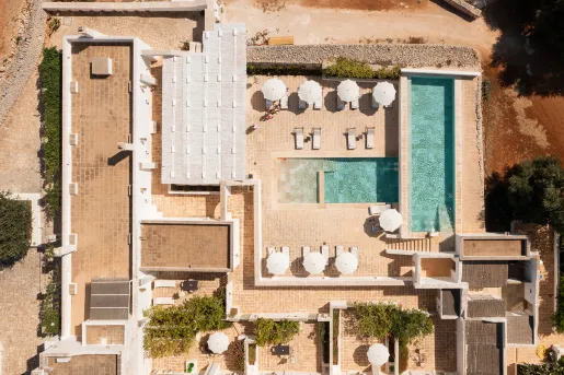 Top view of an outdoor pool and stone building complex