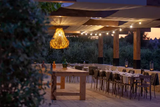 Outdoor patio with dining tables and a large light fixture