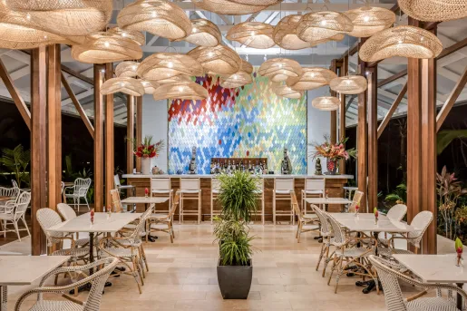 Hotel dining room and bar with structural light fixtures hanging from the cieling