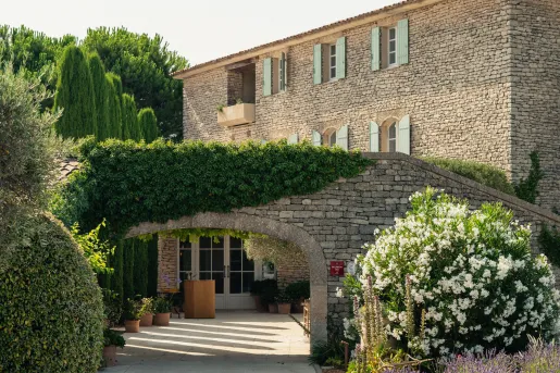 Large, stone archway with plants and trees to the left