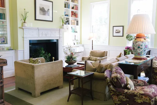 Living room with beige, cushioned sofas in front of a fireplace