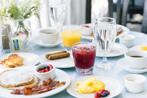 Plate of breakfast foods on top of a white table