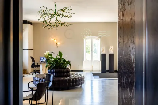 Hotel lobby with marble flooring and a leather couch in the center