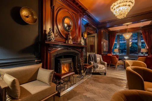 Lobby with art pieces on the wall and cushioned chairs around the room