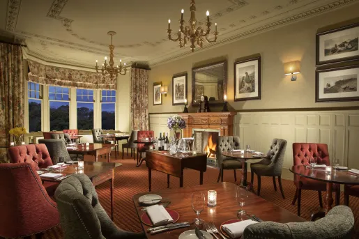 Small, intimate dining area with cushioned chairs and wooden dining tables