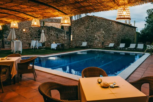 Outdoor pool with dining tables surrounding the area