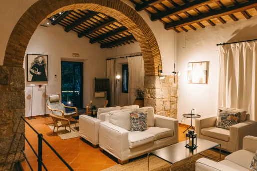 Seating and lounge area with beige couches and stone walls