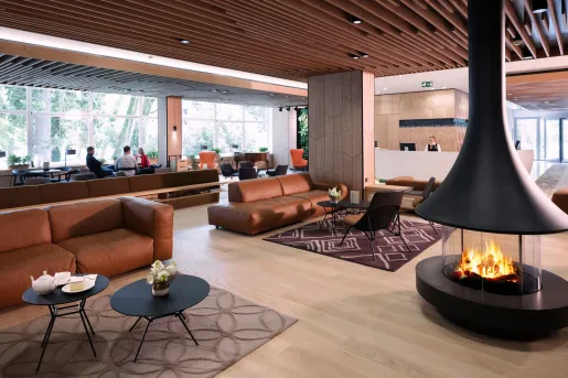 Indoor lounge with a fireplace and leather couches