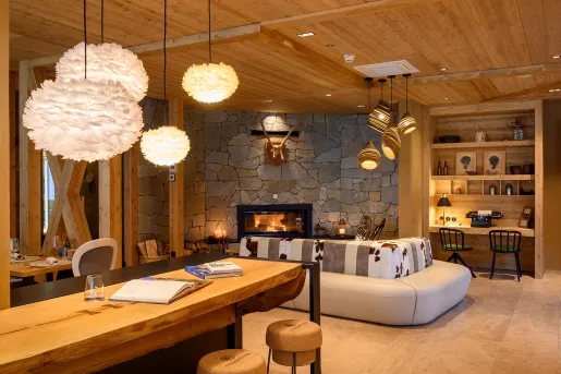 Indoor lobby with stone walls and wooden pillars and fluffy light fixtures