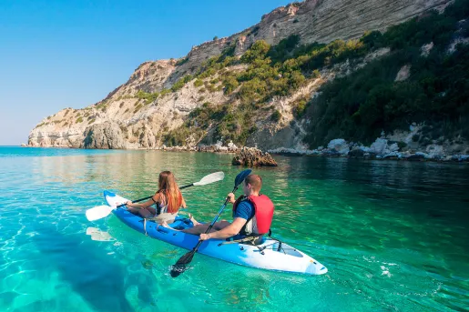 Man and woman paddling on a kayak in a lake