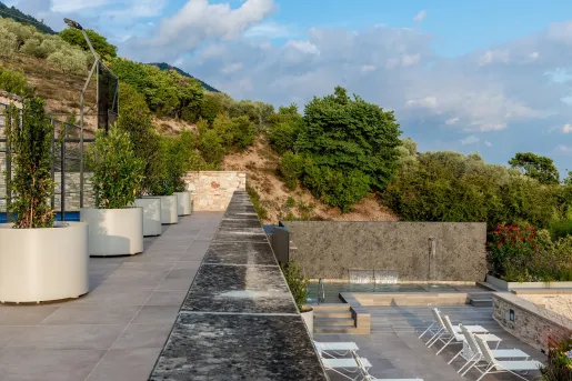 Outdoor rooftop balcony, with a pool on a lower level balcony