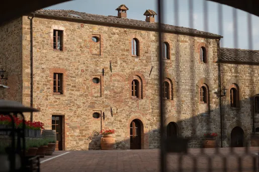 Exterior view of stone building with a stone patio in front