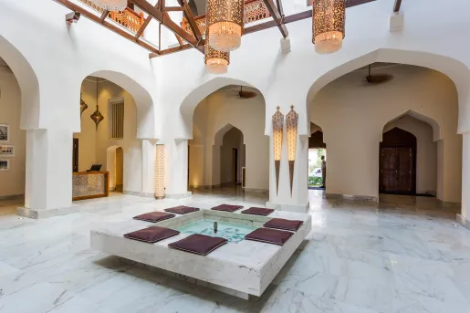 Large building foyer with a mini fountain in the center and large archways surrounding