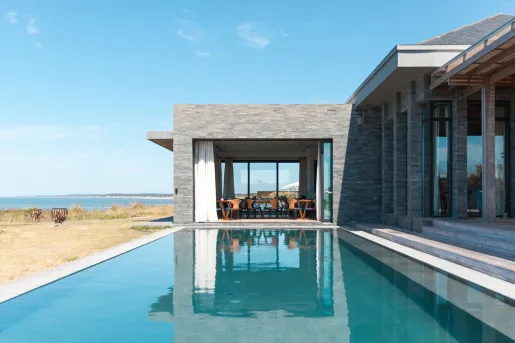 Outdoor pool with a gray stone building in the background