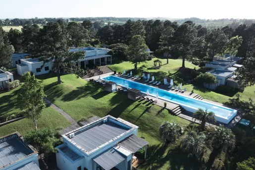 Exterior, sky view of hotel complex surrounded by trees