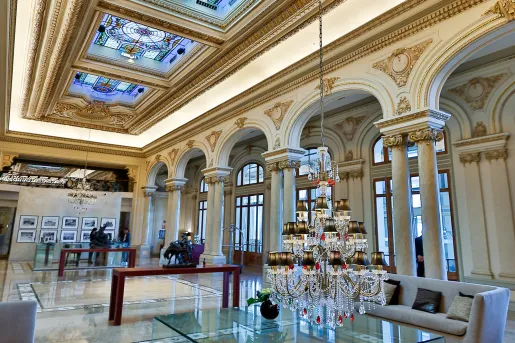 Hotel lobby with couches and a low-hanging chandelier