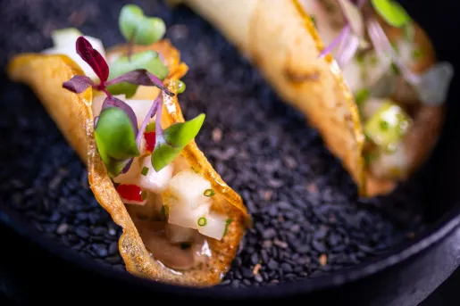 Curled fruit slice with onion and microgreens