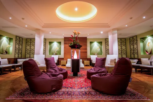 Seating and lounge area with cushioned bean bags and a centerpiece with a flower