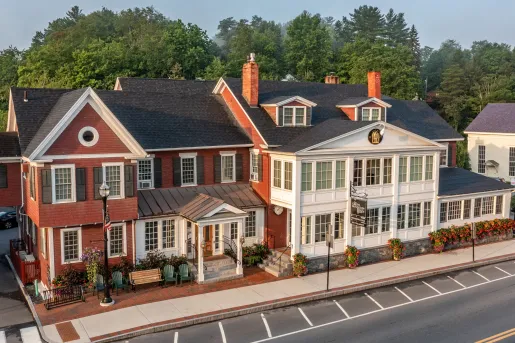 Exterior view of red and white building with plants in front