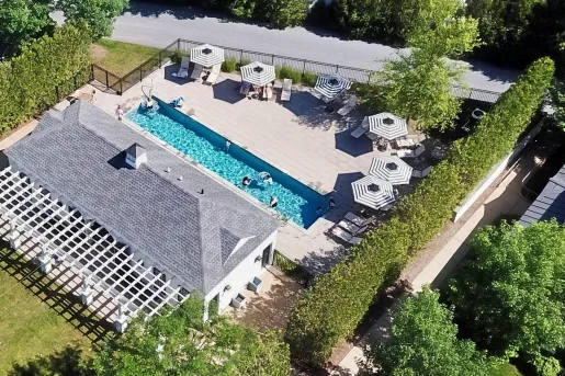 Sky view of gray building with an outdoor pool to the right