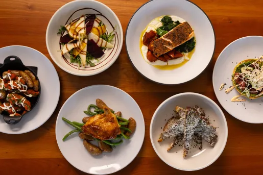 Plate of foods consisting of roasted chicken, fish and vegetables