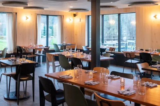 Restaurant dining hall with wooden tables and colorful chairs