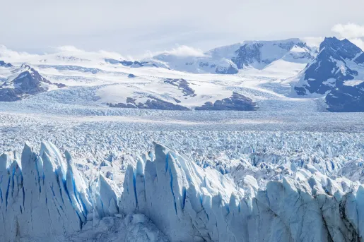 Snow caps and glaciers with mountains in the distance