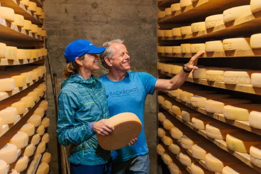 Backroads guests looking at wheels of cheese