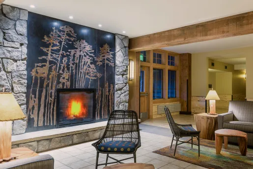 Hotel Lobby with cushioned chairs in front of a stone fireplace