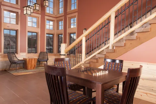 Outdoor patio with tables and a chess set in the center