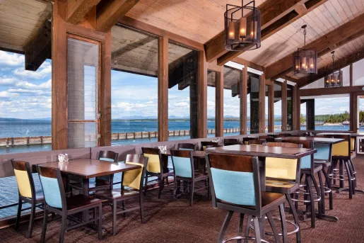 Restaurant dining area with large windows looking out towards the ocean