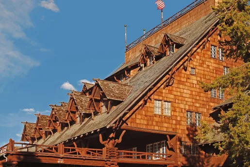 Exterior view of wooden cabin with an American flag at the top flag pole