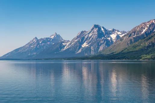 Large lake with tall, snow-capped mountains in the distance