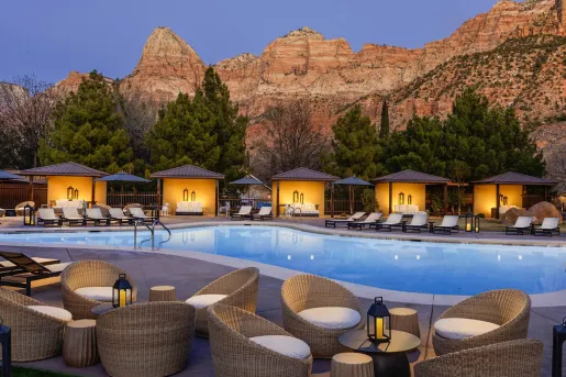 Outdoor pool with woven chairs and pool beds surrounding