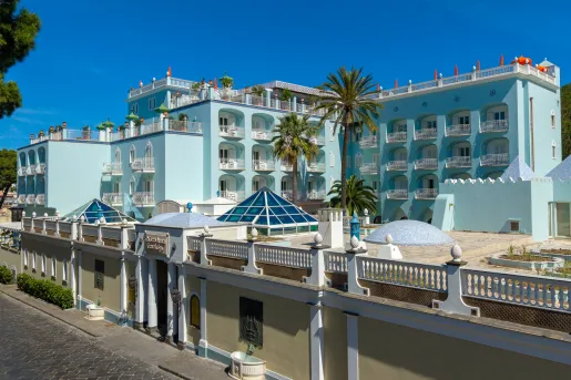 The light blue exterior, tiered architecture and glass pyramid skylights of the Palazzo Manzi Terme & Spa located in Casamicciola Terme on the island of Ischia, Italy.