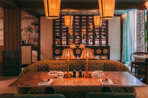 Lounge area with a large sofa and marble table, with warm illuminated lights