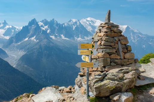 Top of a mountain with a rock pyramid and a wooden sign