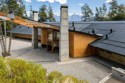 The entrance of Calfuco Wine Hotel & Spa features a striking modern design blending rustic materials, located in Villa La Angostura, Neuquén Province, Argentina.