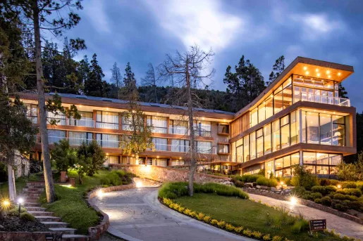 Hotel Alto Traful in Villa Traful, Argentina, featuring a modern architectural design with extensive glass walls and wooden paneling.