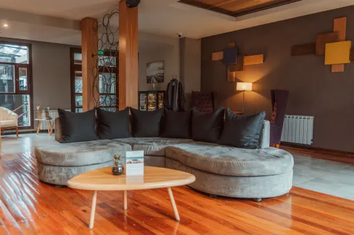 Lounge and seating area with a large sofa on a wooden floor