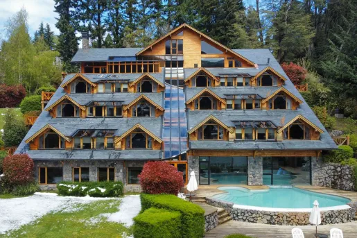 Exterior view of multi-story hotel building with a pool in front