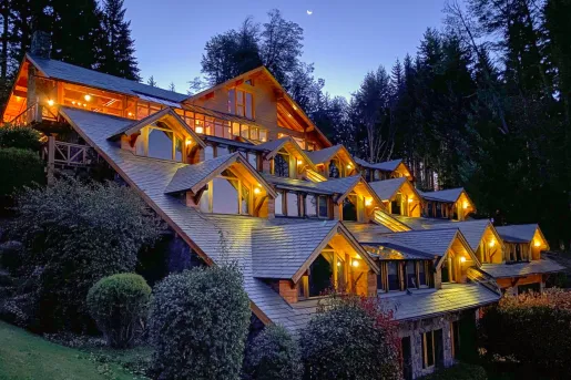 Exterior view of a multi-story building with warm lights in the evening