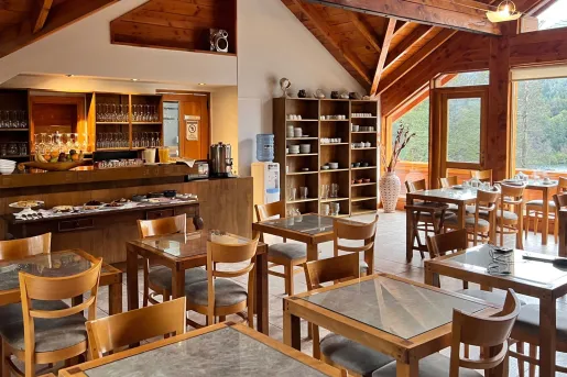 Restaurant with square dining tables and wooden chairs