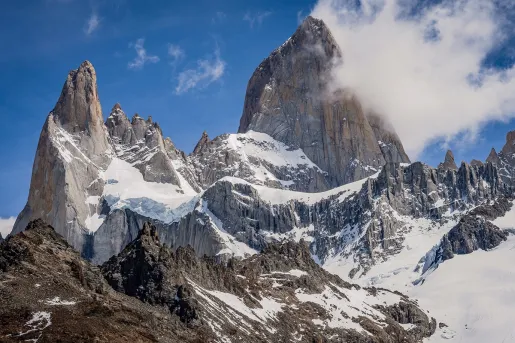Snowy mountains with foggy clouds in the sky
