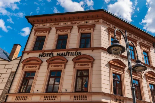 Exterior view of orange hotel building with the blue sky in the background